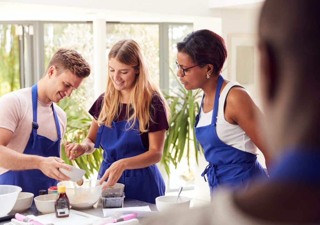 male-and-female-adult-students-measuring-ingredients-in-cookery-class-in-kitchen.jpg